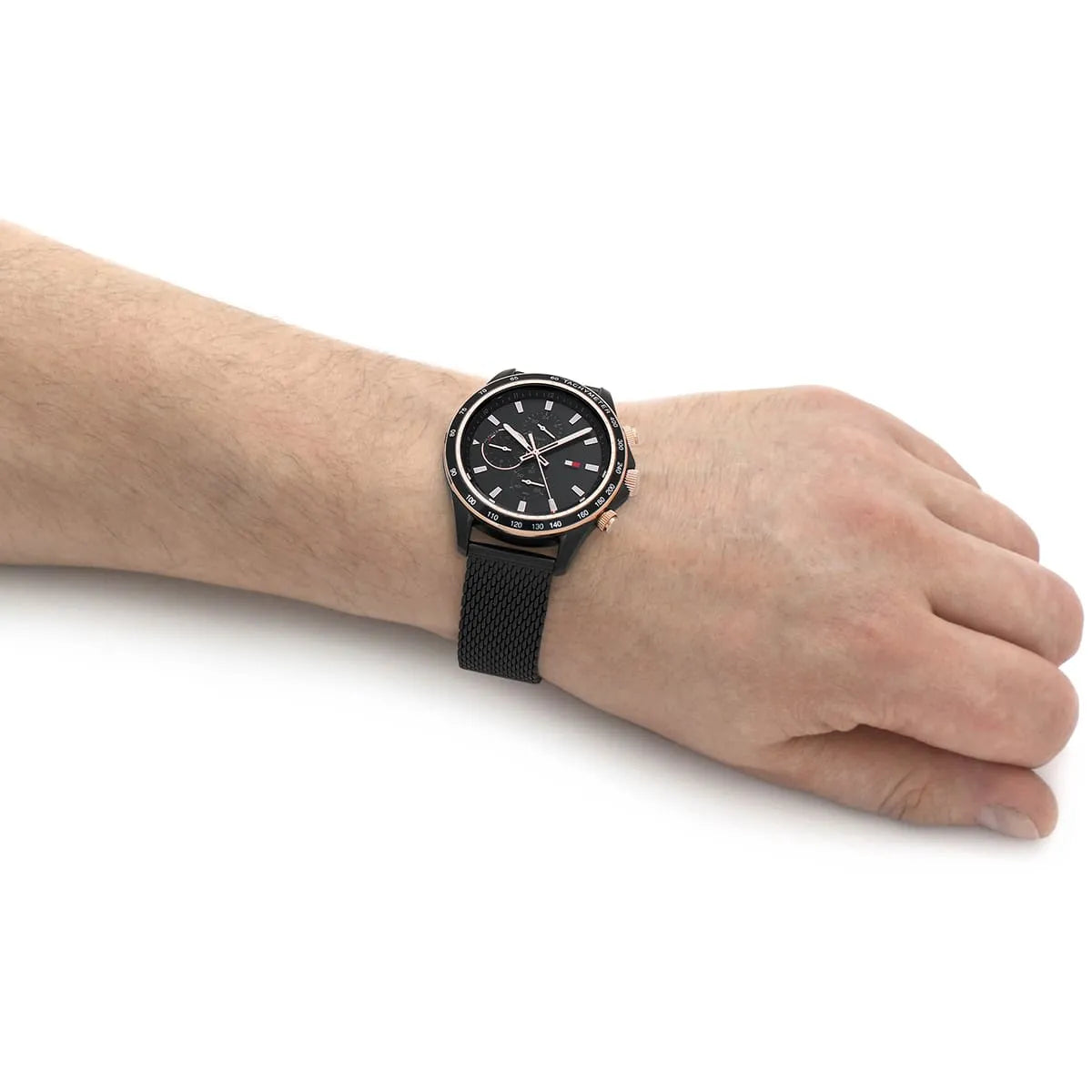 Tommy Hilfiger black chronograph watch worn on wrist with mesh strap