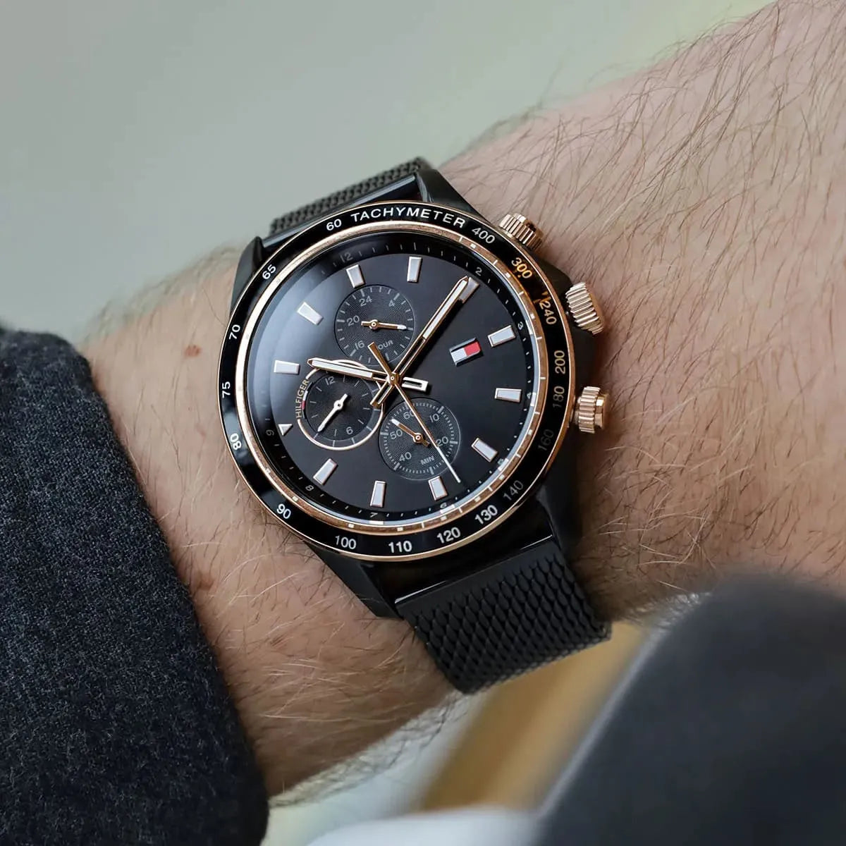 Tommy Hilfiger black mesh watch worn on wrist showing dial and strap detail