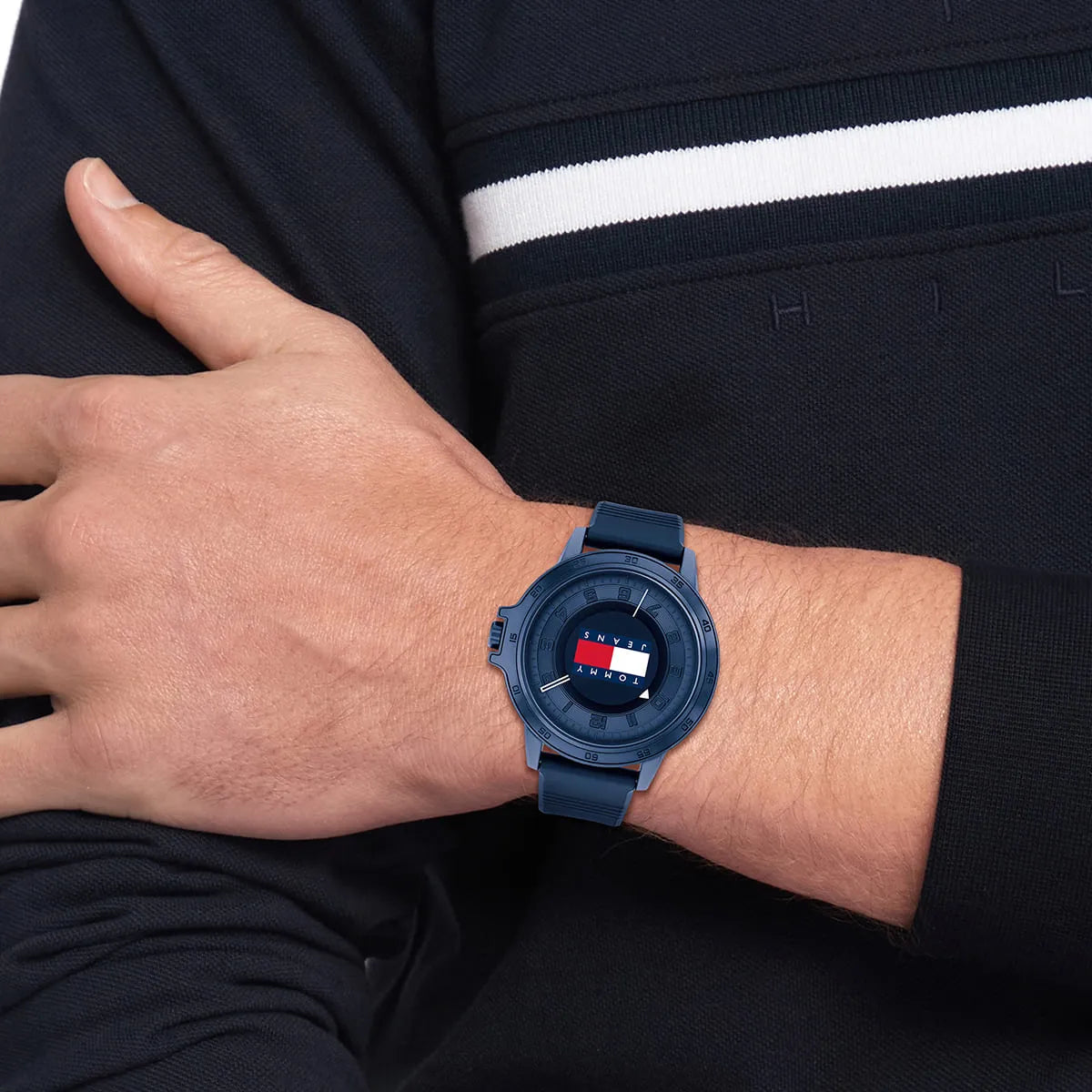 Tommy Hilfiger Houston blue watch on wrist displaying blue dial with Tommy Jeans flag logo