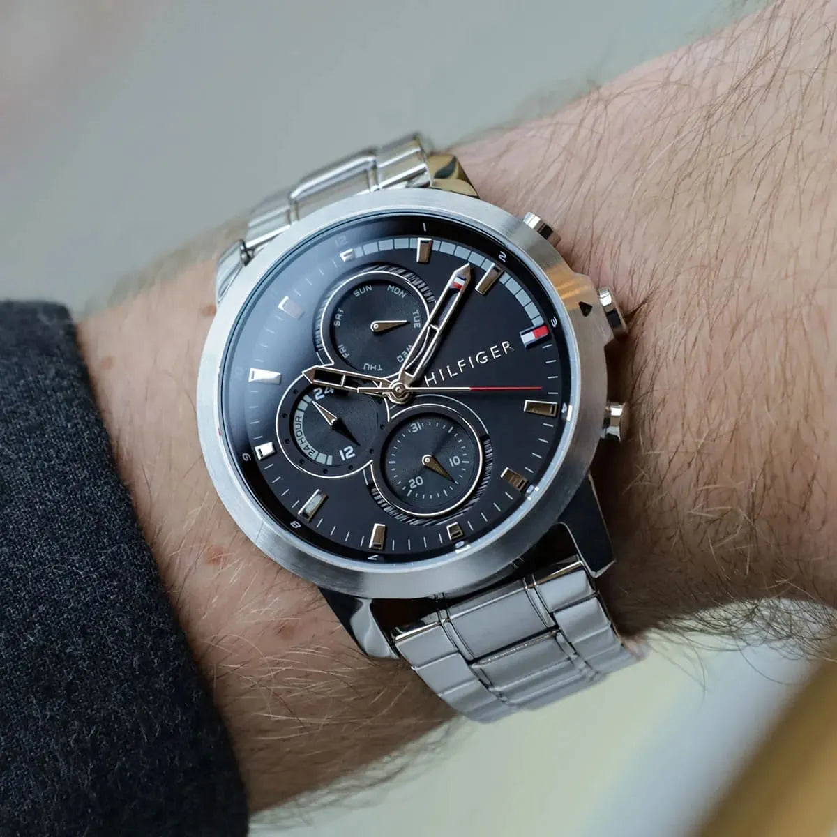 Tommy Hilfiger chronograph watch worn on wrist with stainless steel bracelet