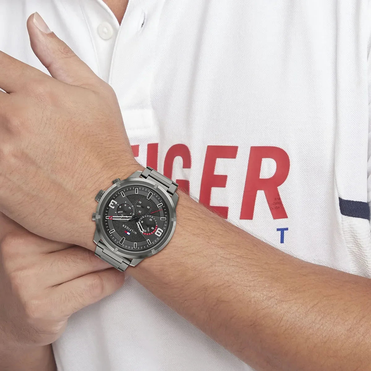 Tommy Hilfiger men's watch worn on wrist showing black dial and stainless steel bracelet