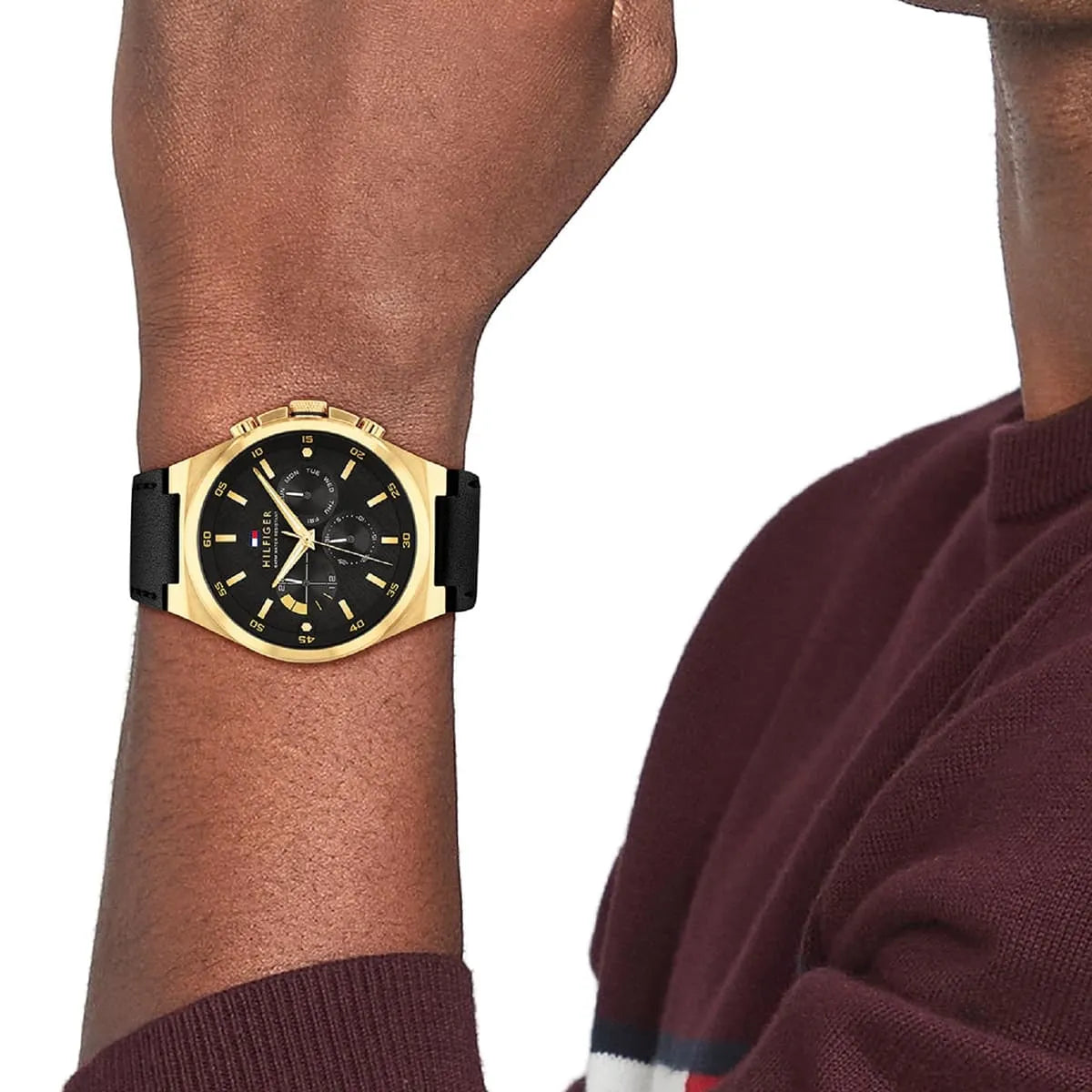 Tommy Hilfiger Dexter watch on wrist with black leather strap and gold-tone case