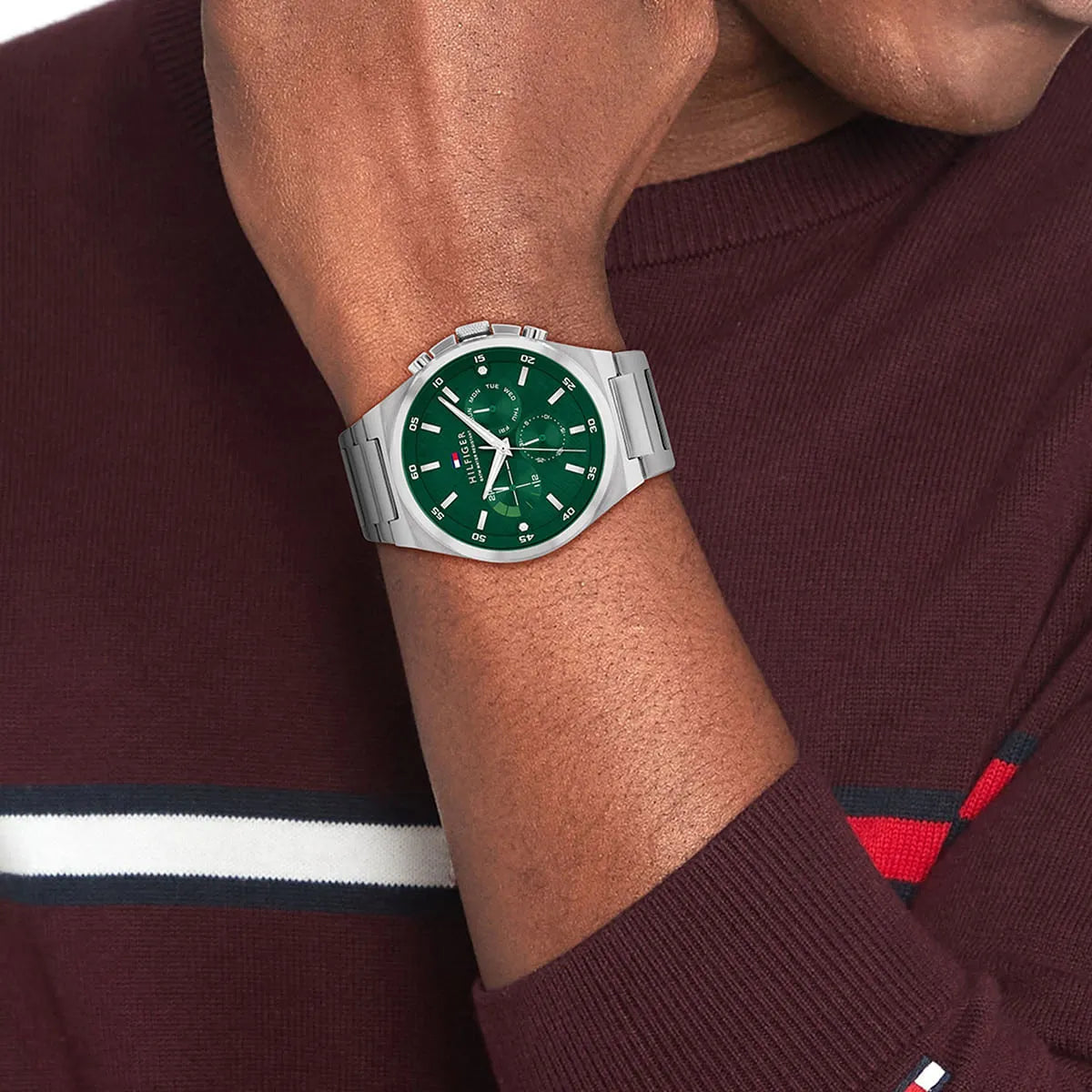 Tommy Hilfiger Dexter men's watch on wrist displaying green multifunction dial