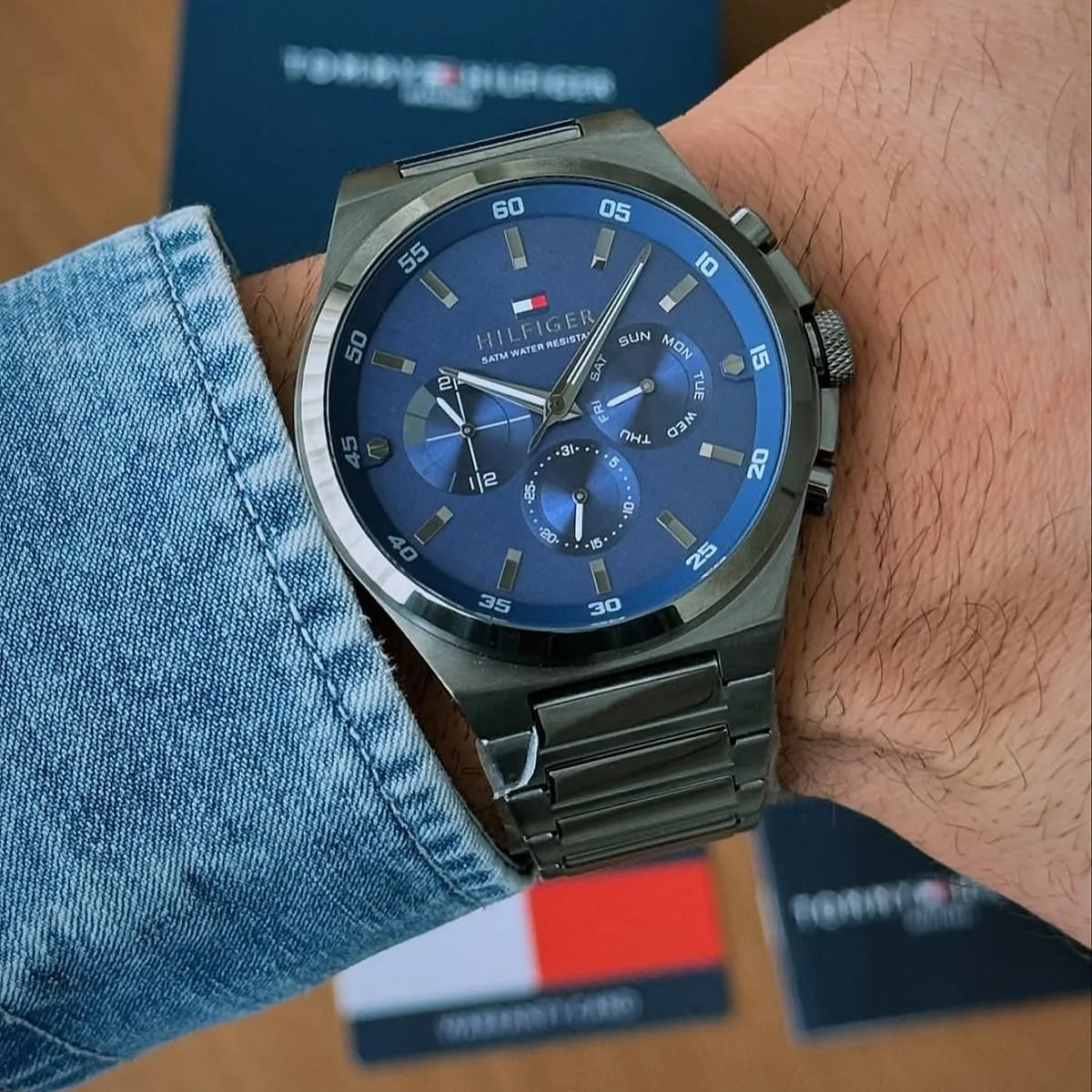 Tommy Hilfiger Dexter watch worn on wrist with blue dial visible