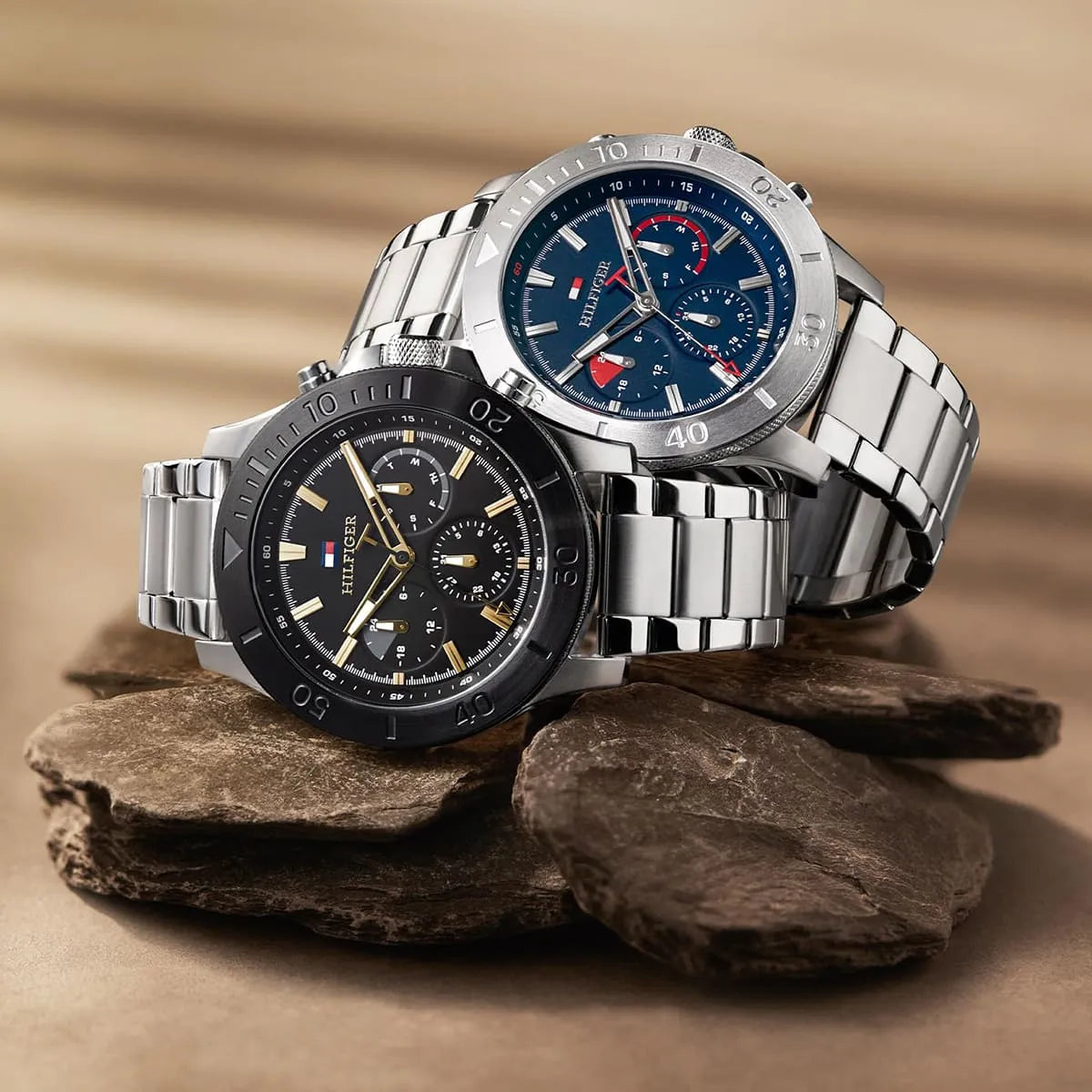 Two Tommy Hilfiger Bryan chronograph watches displayed on rock surface