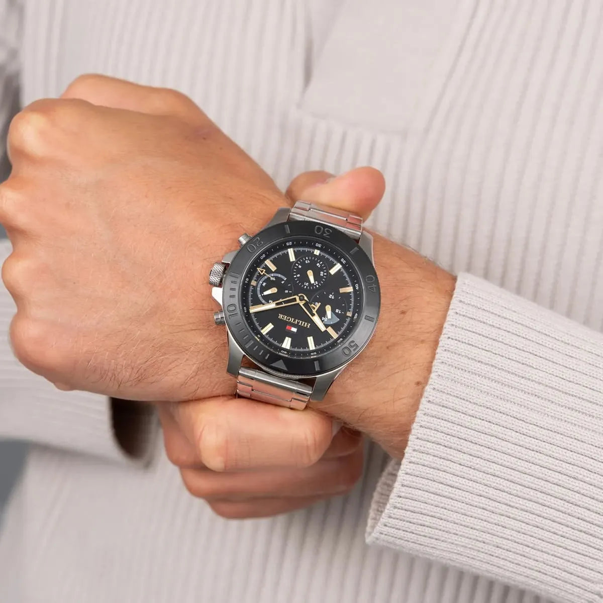 Tommy Hilfiger men's chronograph watch worn on wrist with black dial and steel bracelet
