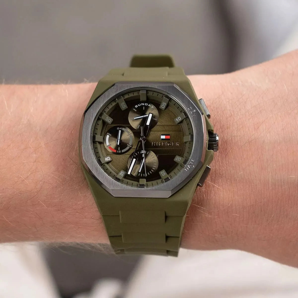 Tommy Hilfiger green dial multi-function watch worn on wrist showing octagonal case