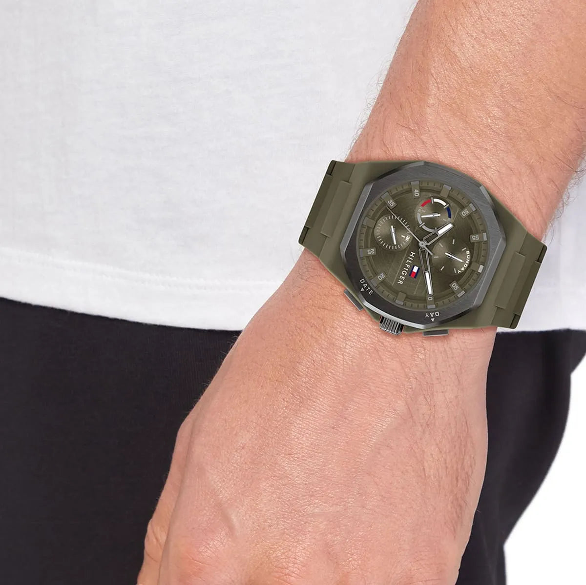 Tommy Hilfiger green silicone watch worn on wrist with chronograph subdials visible