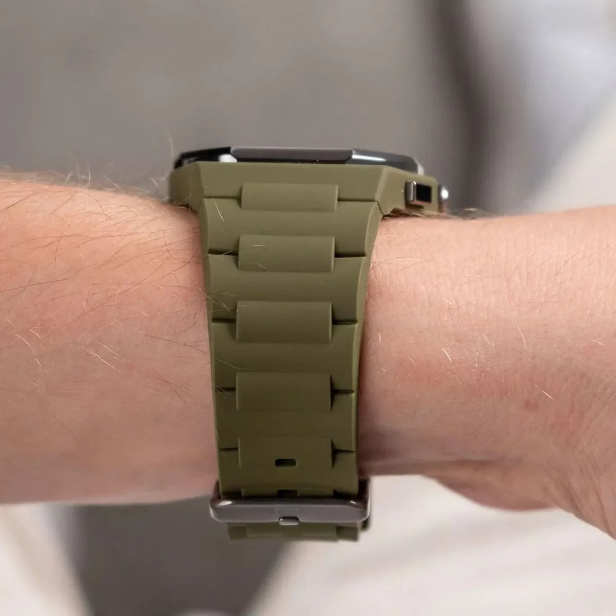 Tommy Hilfiger watch showing olive green silicone strap detail and clasp on wrist