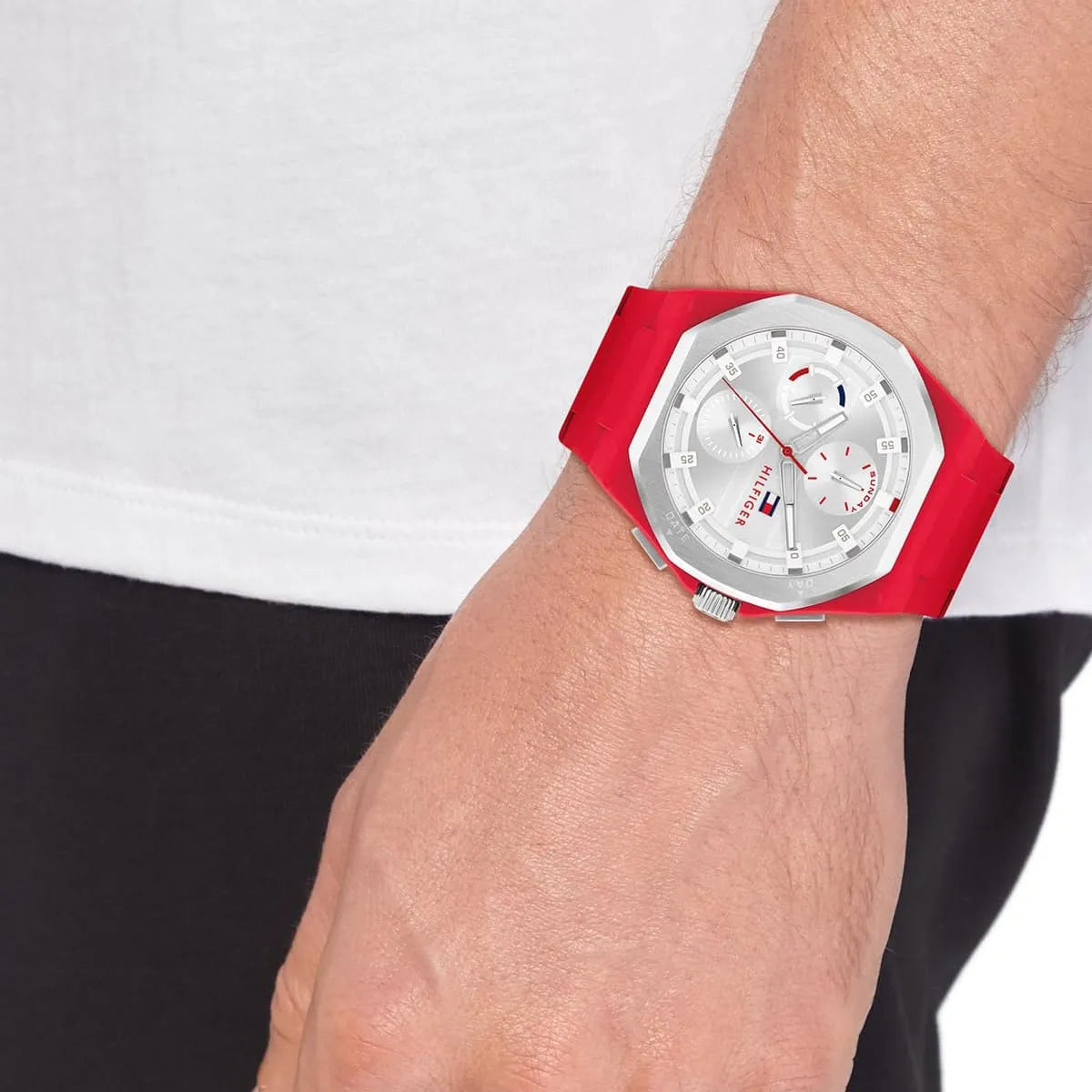 Tommy Hilfiger Neo watch on wrist at angle showing red rubber strap and silver bezel