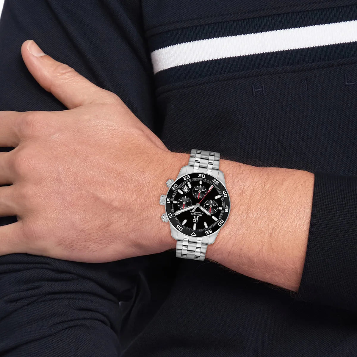 Tommy Hilfiger TH85 chronograph on wrist showing black dial and red chronograph hands