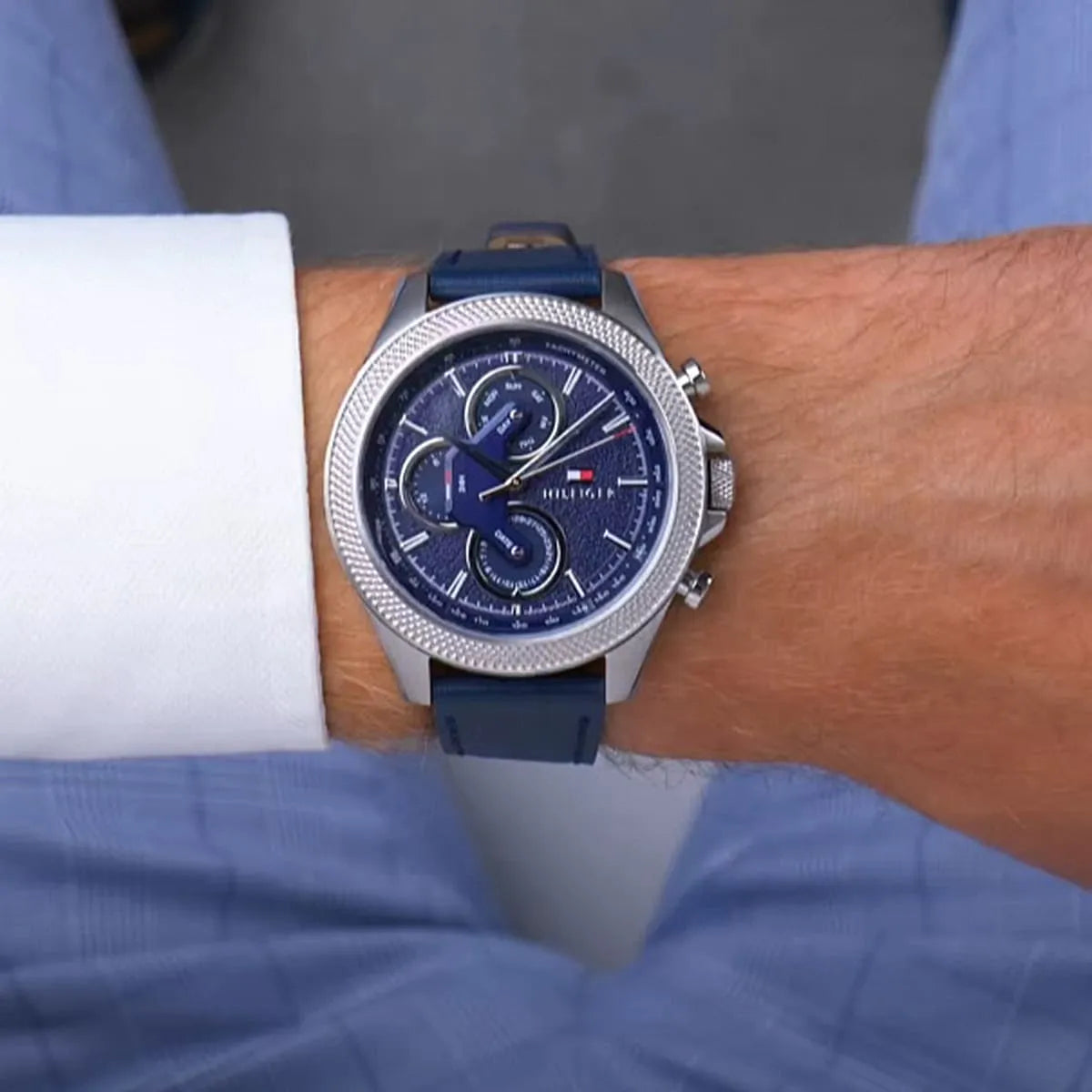 Tommy Hilfiger Clark watch worn on wrist showing blue dial and navy leather strap