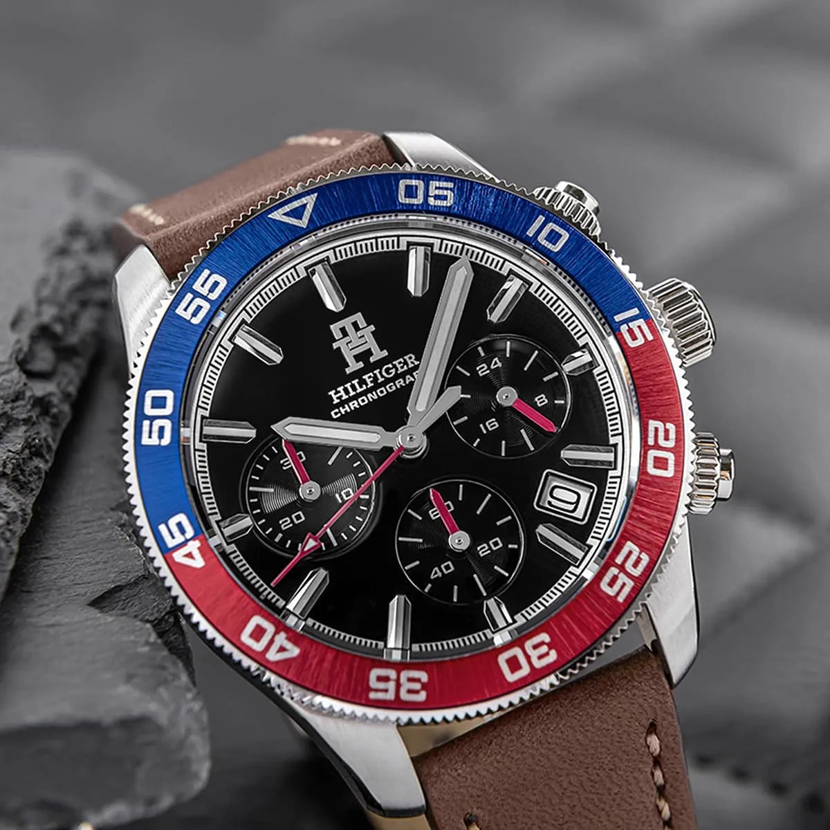 Close-up of TH85 black dial with chronograph subdials and red accents
