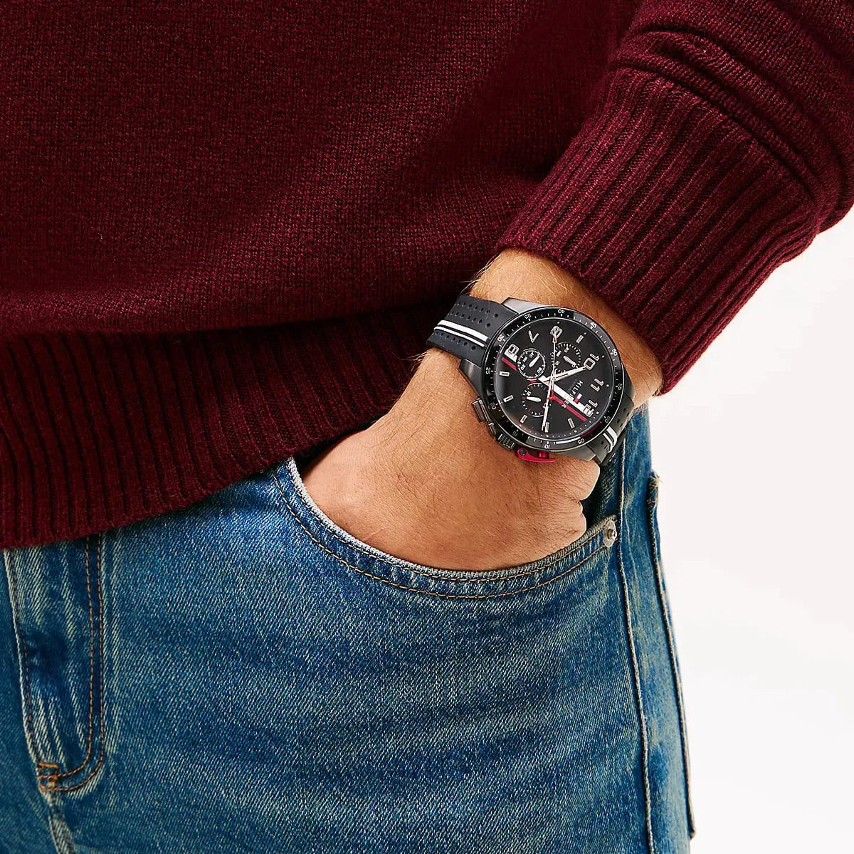 Tommy Hilfiger chronograph watch on wrist with burgundy sweater and jeans