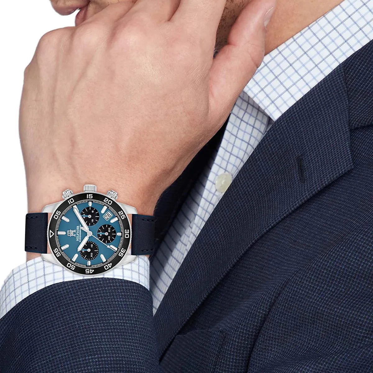 Tommy Hilfiger blue chronograph watch on wrist with dress shirt and blazer