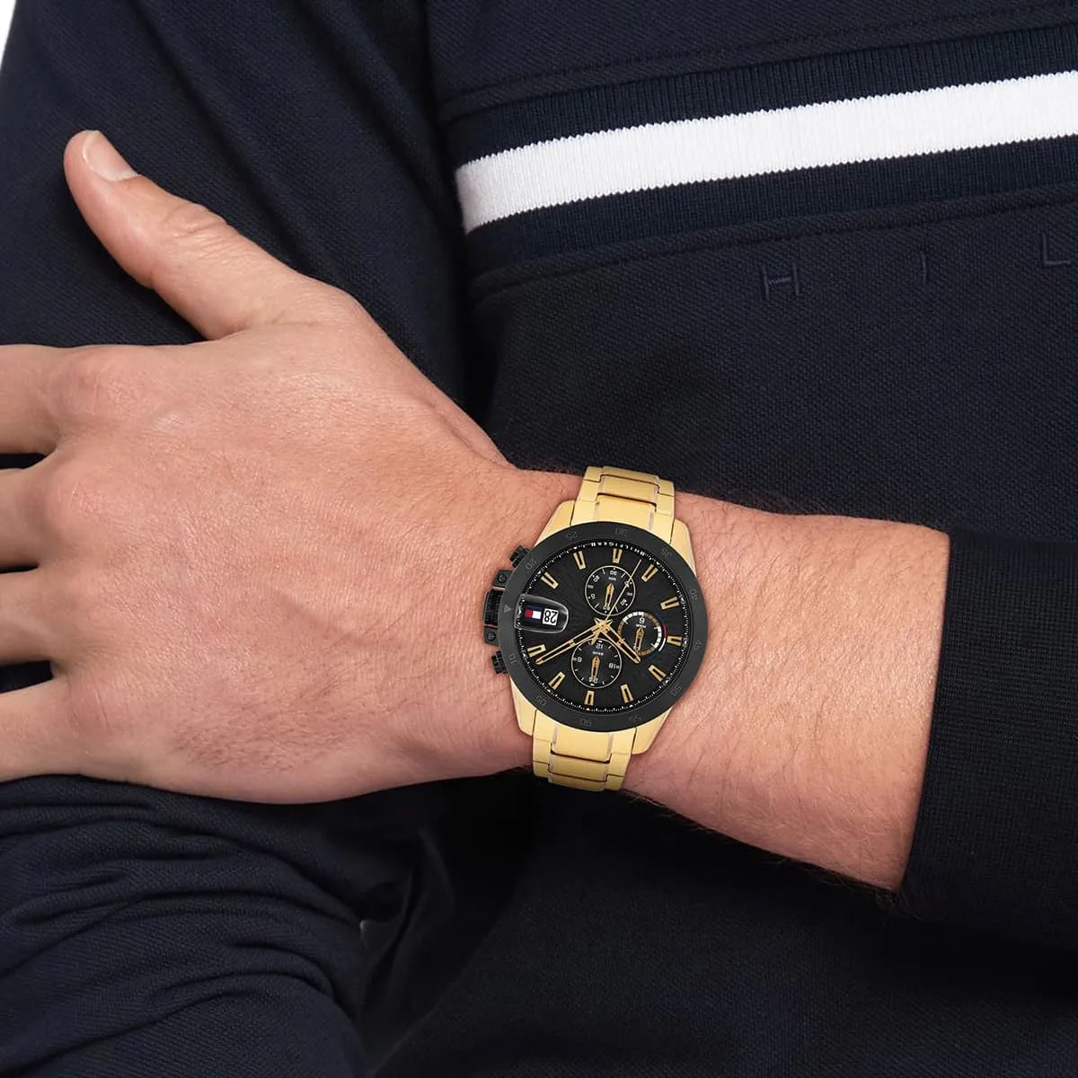 Tommy Hilfiger Jameson chronograph watch worn on wrist with gold strap and black dial