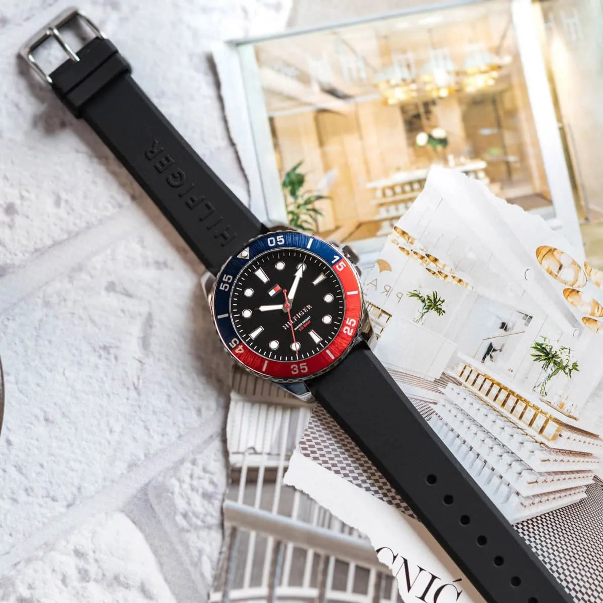 Tommy Hilfiger watch styled on fabric with minimalist accessories