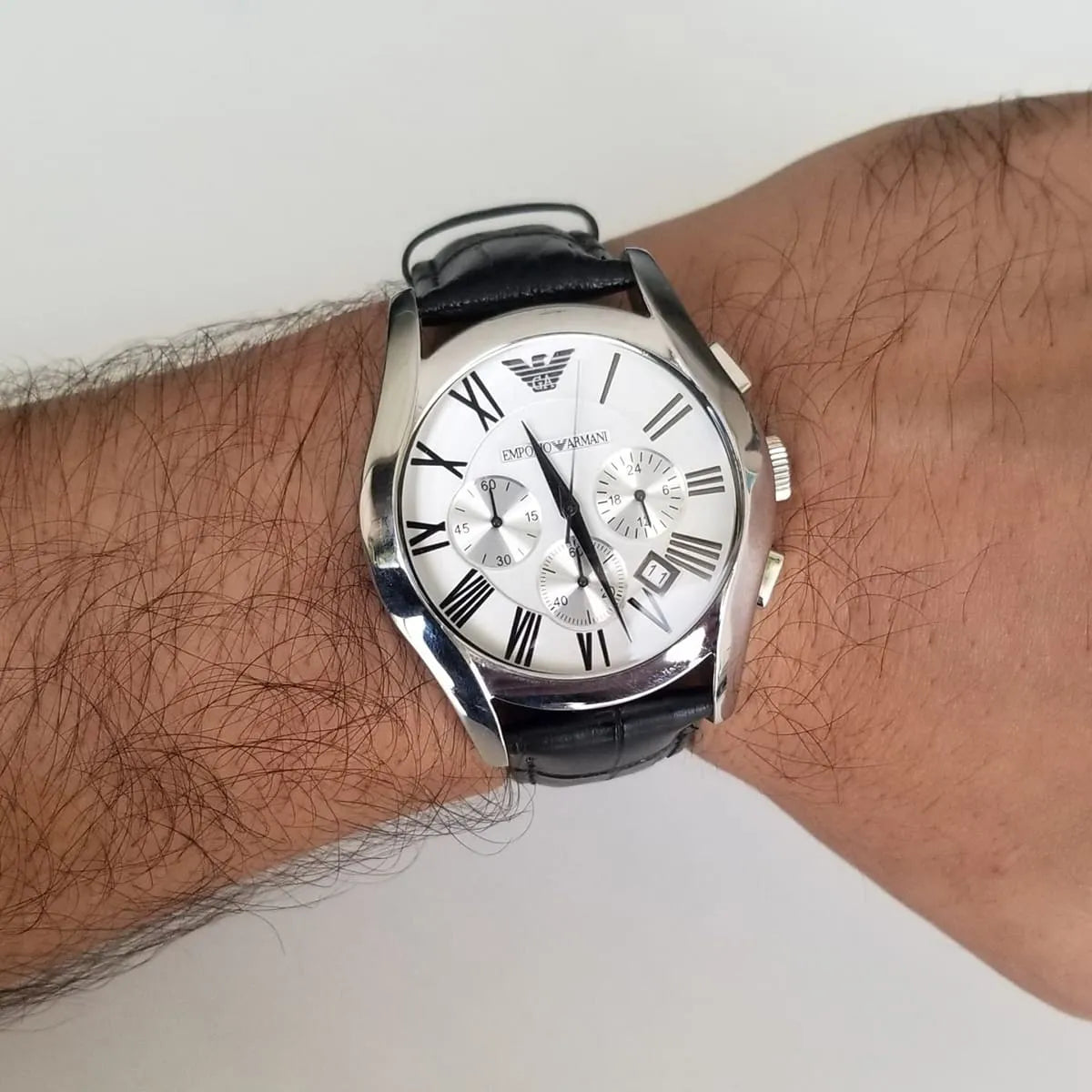 Emporio Armani AR0669 chronograph watch on wrist showing silver dial and black strap
