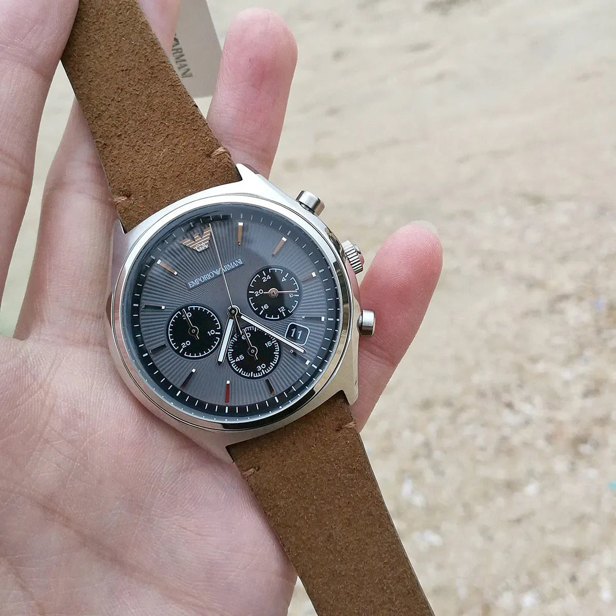 Emporio Armani AR11080 chronograph watch worn on wrist with brown leather strap