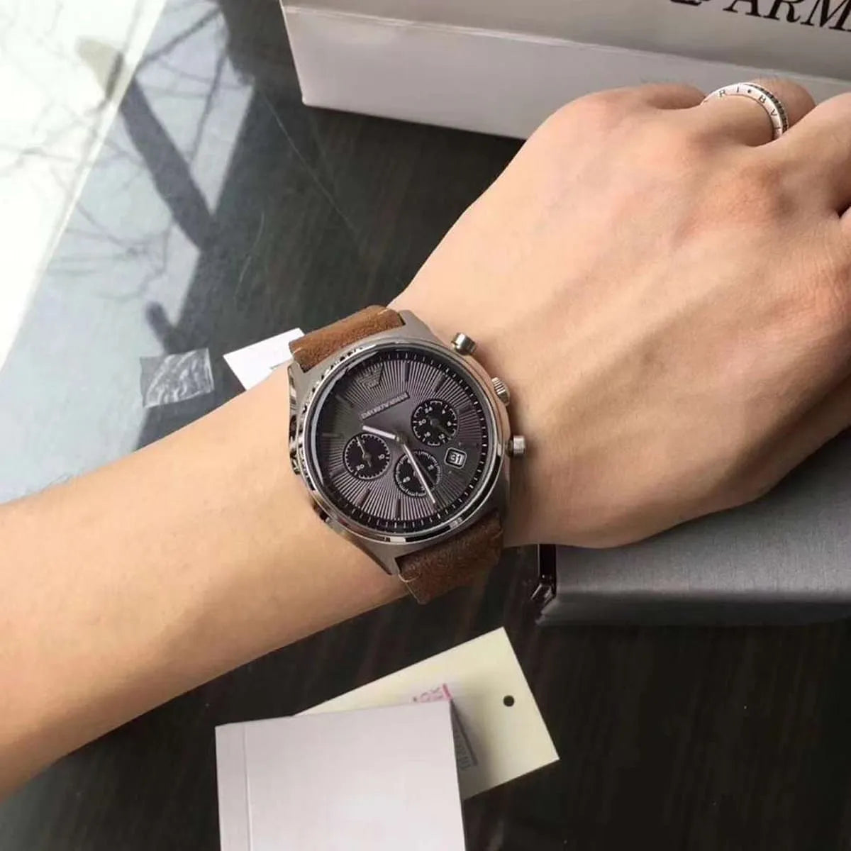 Emporio Armani AR11080 chronograph watch on wrist showing gray dial and brown strap detail