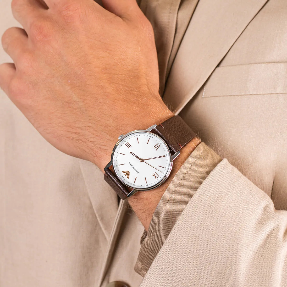 Emporio Armani Kappa AR11173 watch on wrist with beige sweater and brown leather strap visible