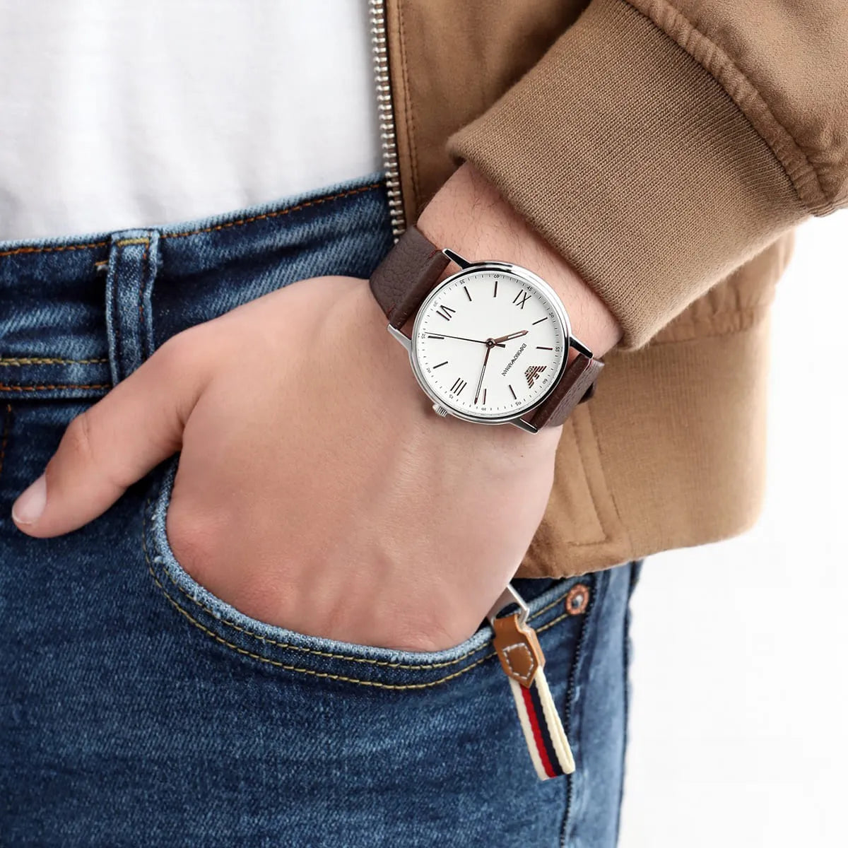 Emporio Armani Kappa AR11173 watch on wrist with brown leather strap and denim jacket