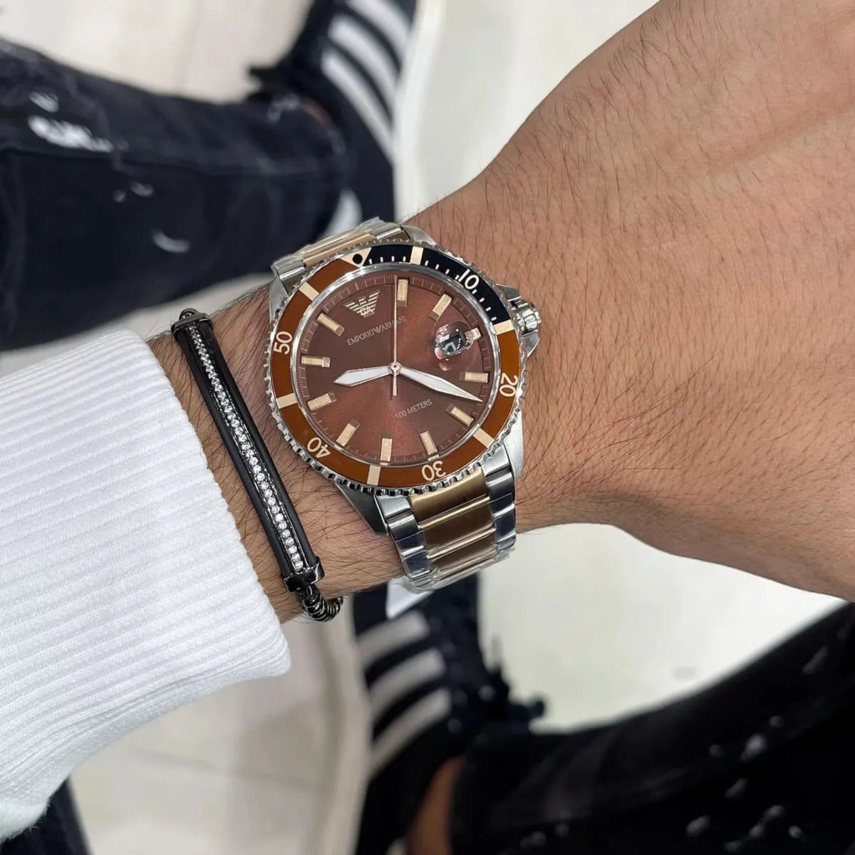 Emporio Armani Sea Explorer AR11340 two-tone watch worn on wrist with brown dial