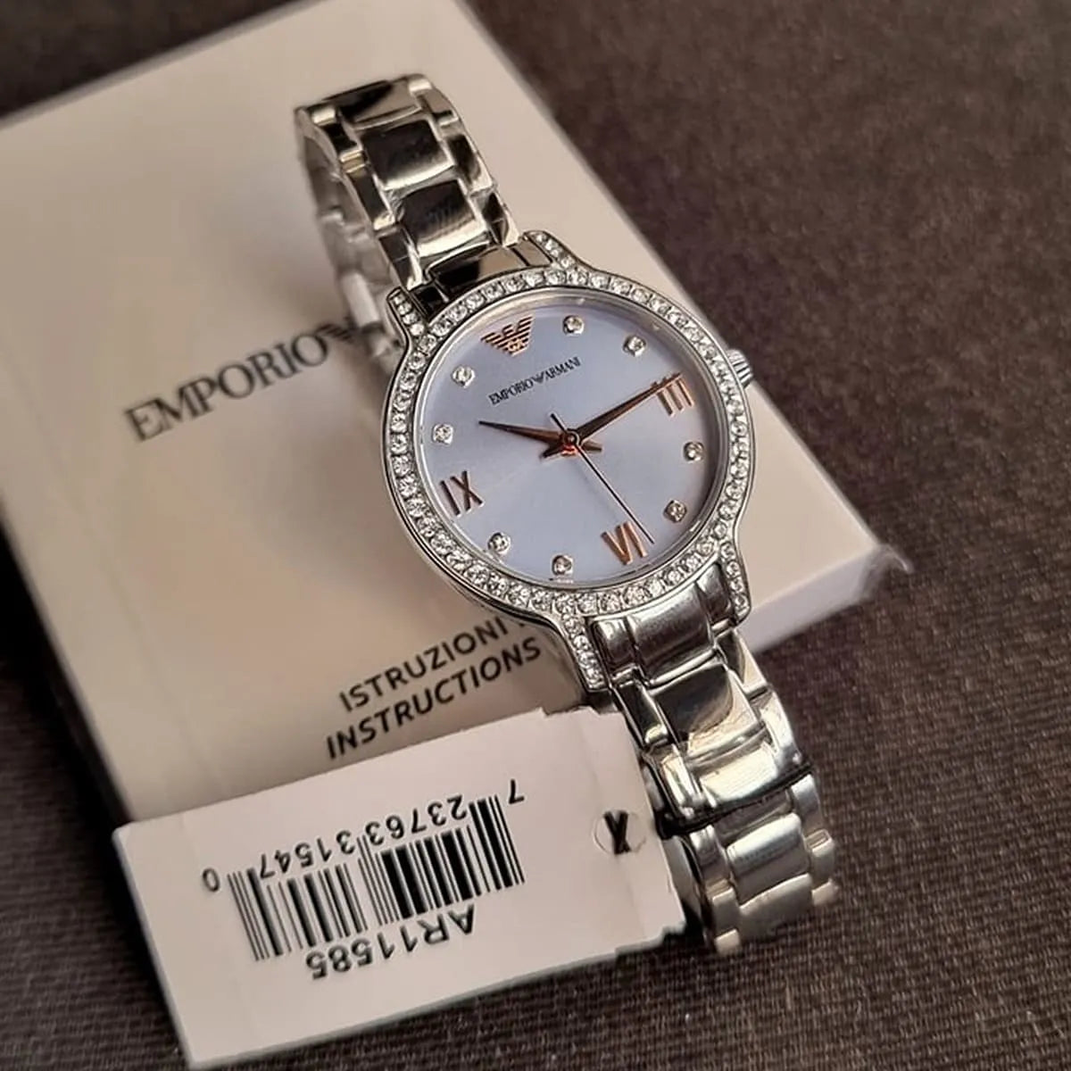 AR11585 Emporio Armani women's watch displayed with packaging and instruction manual on white background