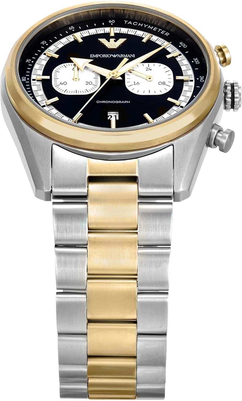 Close-up of black dial with chronograph subdials, tachymeter scale, and gold hands