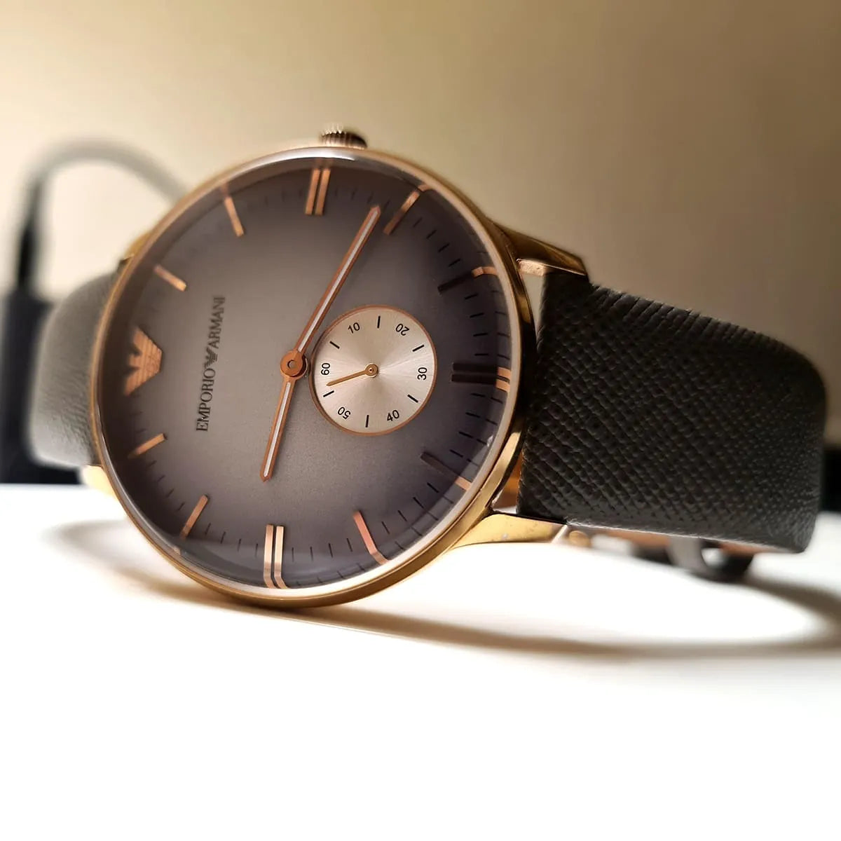 Emporio Armani AR1723 watch on surface with gray dial and rose gold accents visible