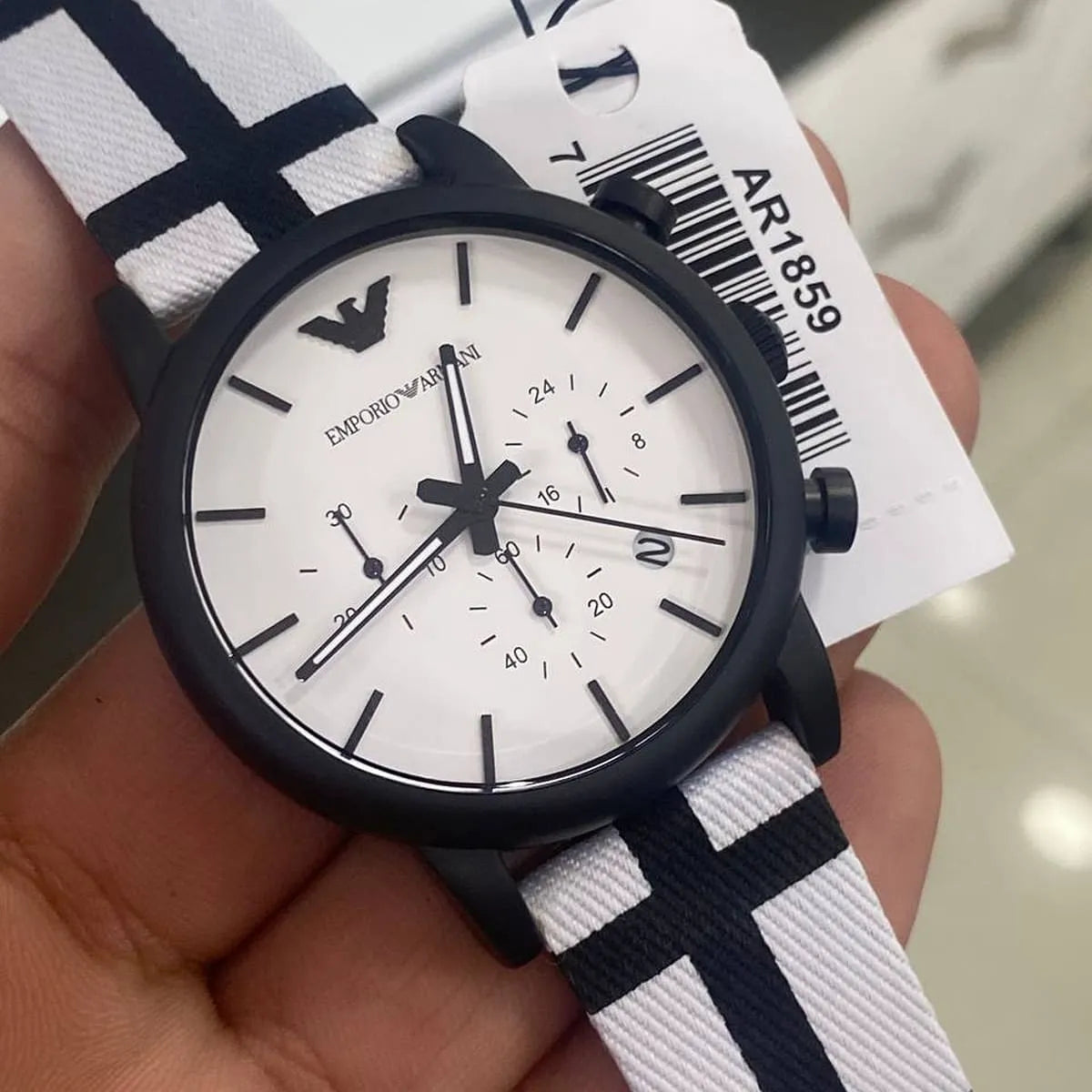 AR1859 Emporio Armani chronograph watch held in hand with product tag visible