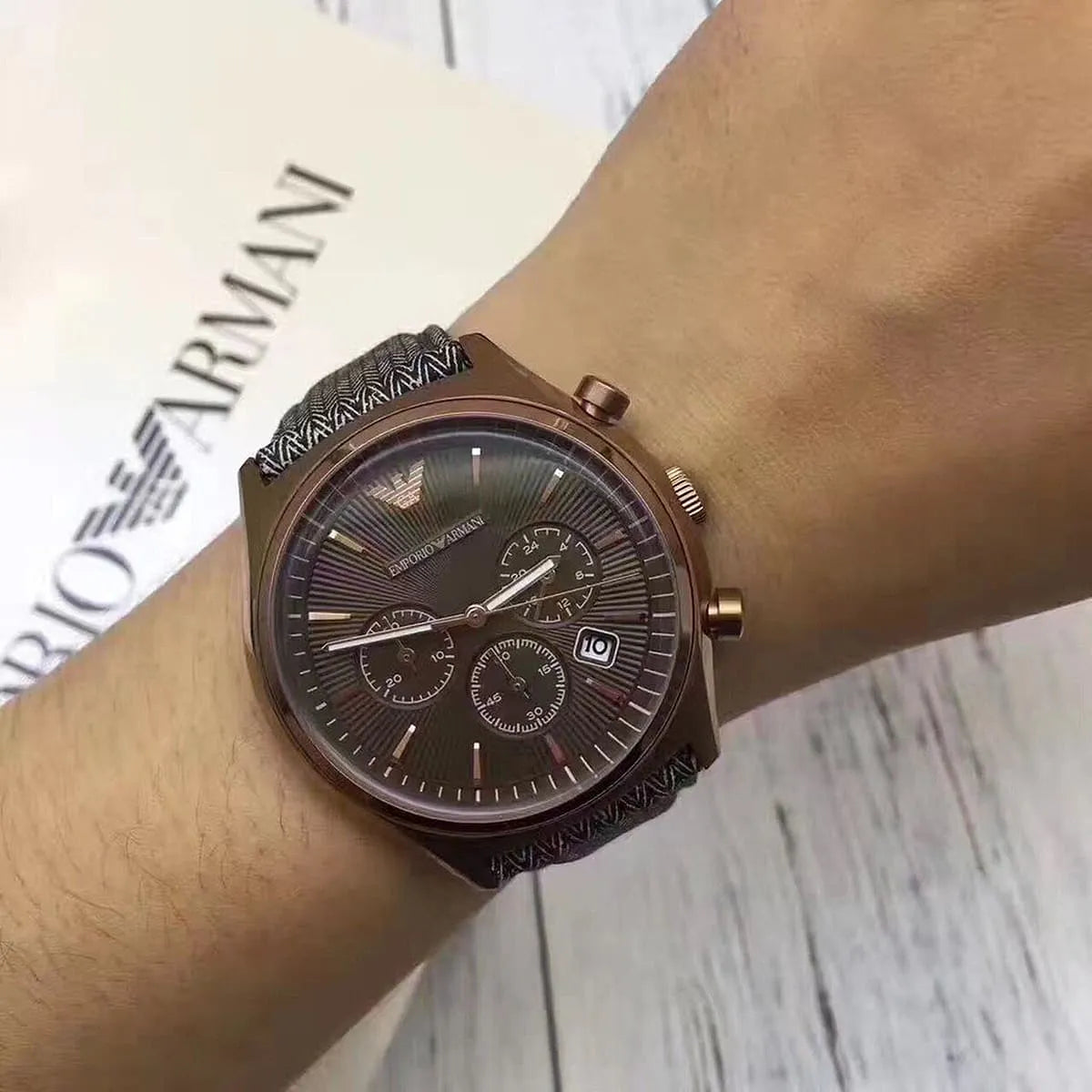 Emporio Armani AR1976 chronograph worn on wrist showing brown dial and gray fabric strap