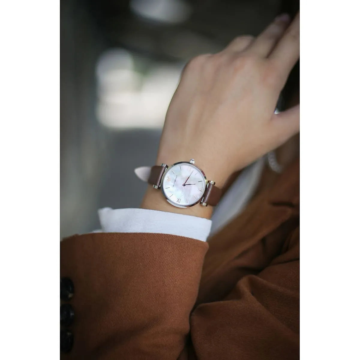 Emporio Armani AR1988 watch on wrist displaying white dial and brown leather strap