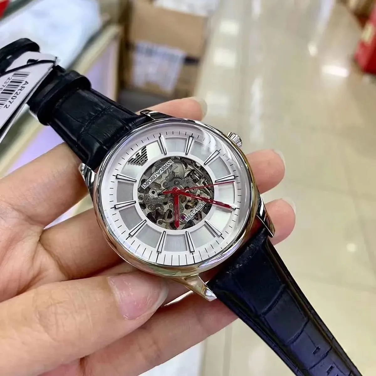 Emporio Armani Meccanico AR2072 skeleton watch worn on wrist with black leather band
