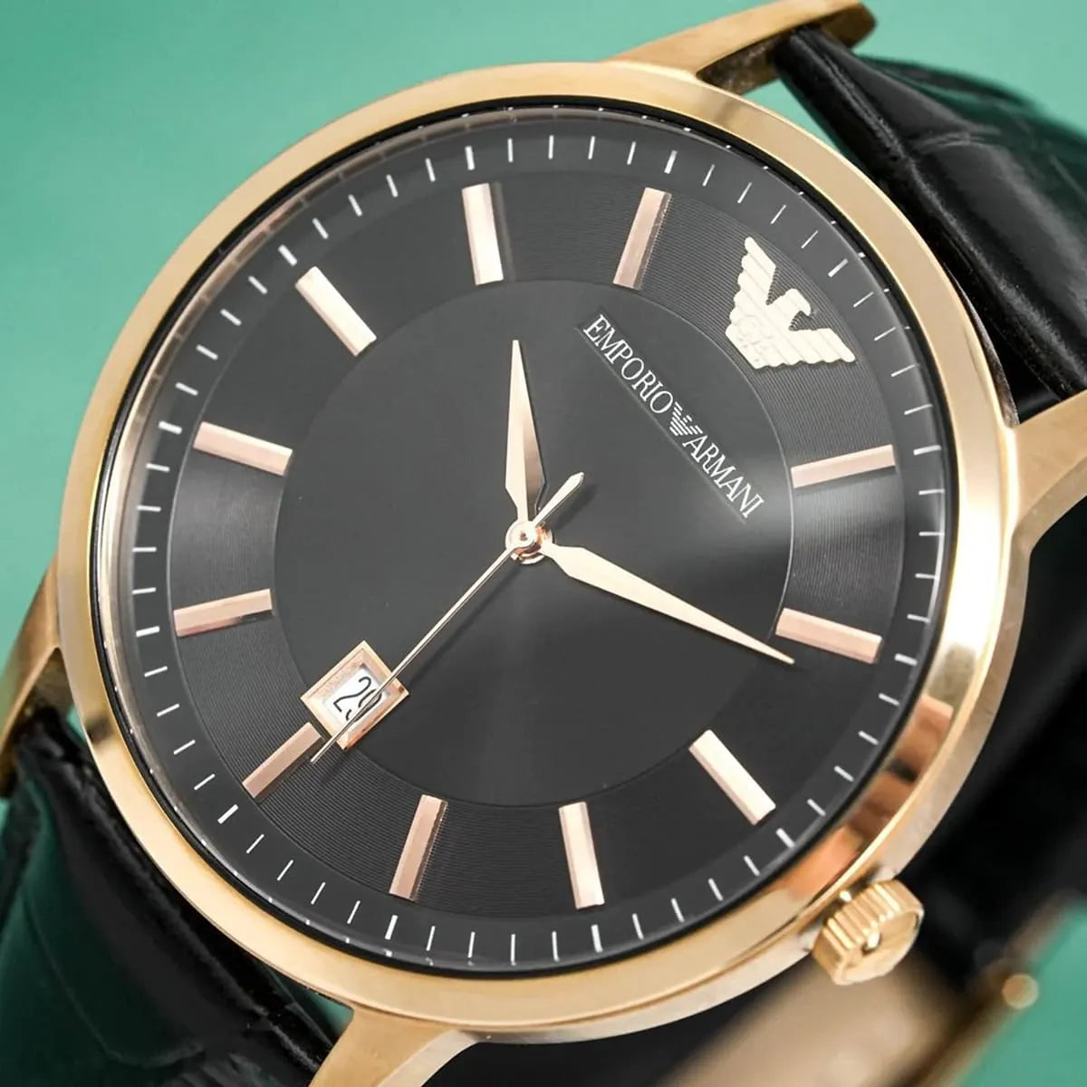 Emporio Armani Renato dial detail with black sunburst face, rose gold indices, and date window