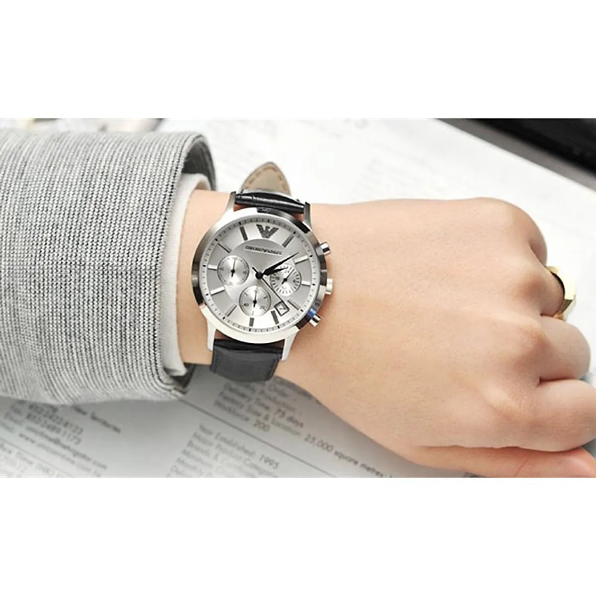 Emporio Armani Renato Uni men's chronograph watch worn on wrist with silver dial and black strap