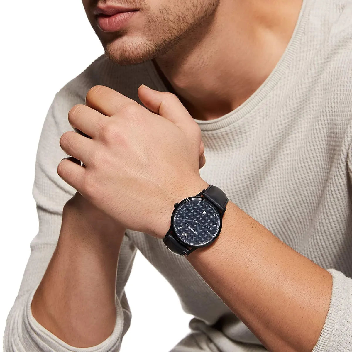 Emporio Armani Renato AR2479 watch on man's wrist showing navy dial and black case