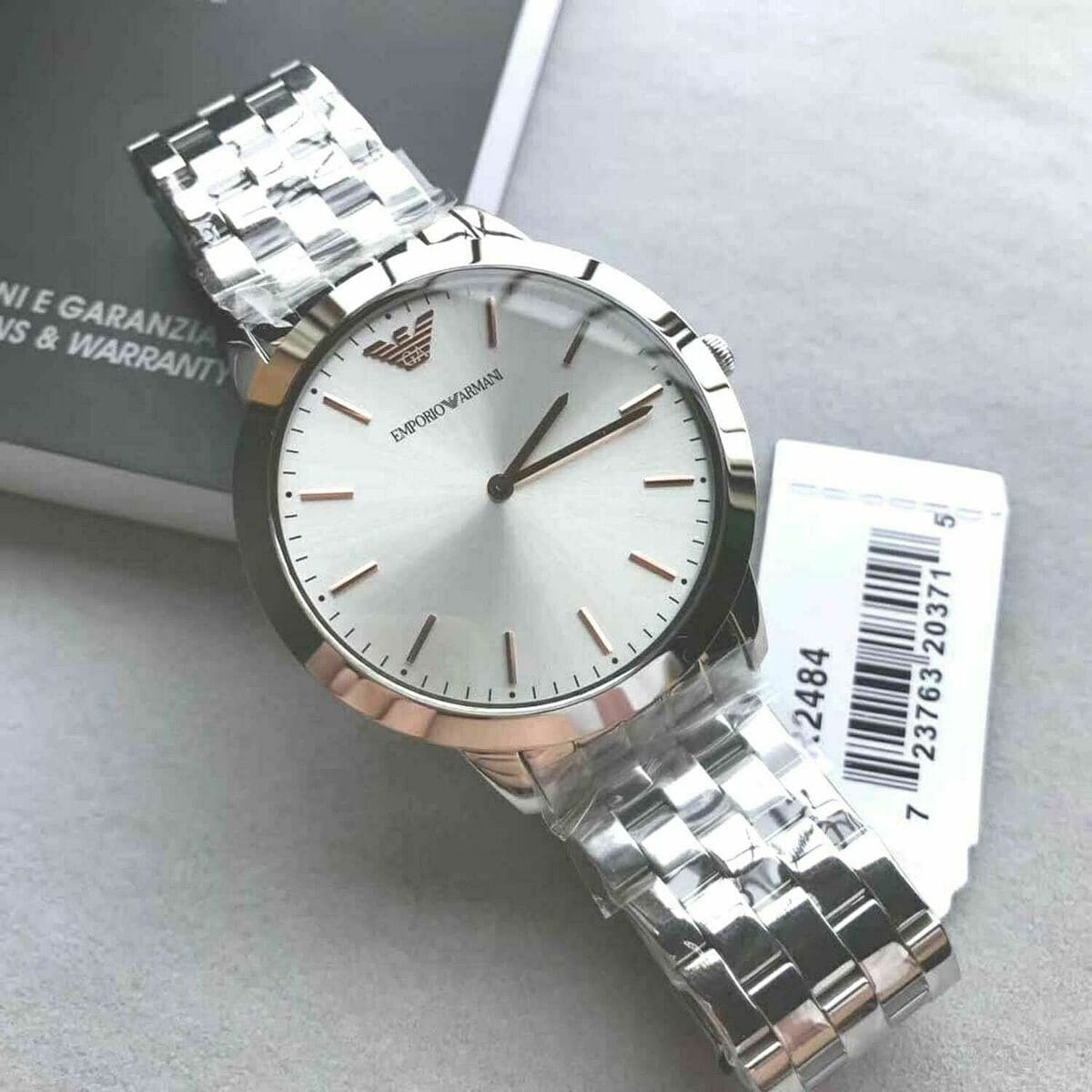 Emporio Armani AR2484 watch displayed with warranty documentation and SKU tag