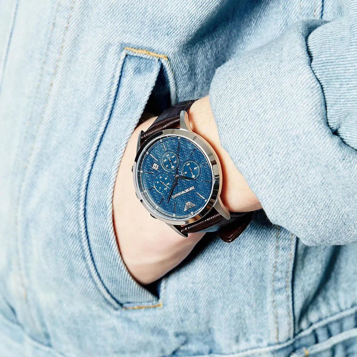 Emporio Armani Renato Large AR2494 worn on wrist against blue denim jacket