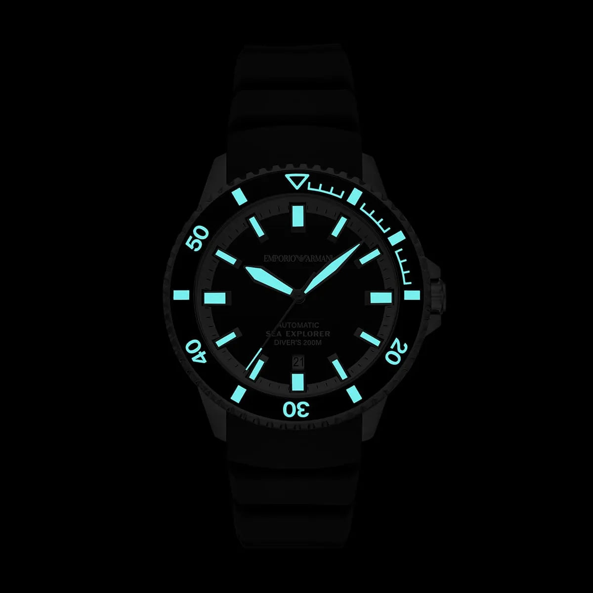 Close-up of Emporio Armani Sea Explorer dial with luminous hands and index markers glowing in dark