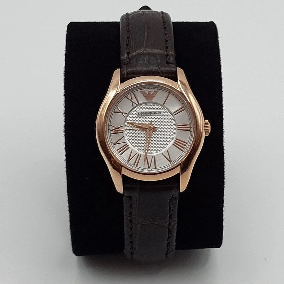 Emporio Armani AR9035L rose gold watch displayed on black cushion showing white dial and brown leather band