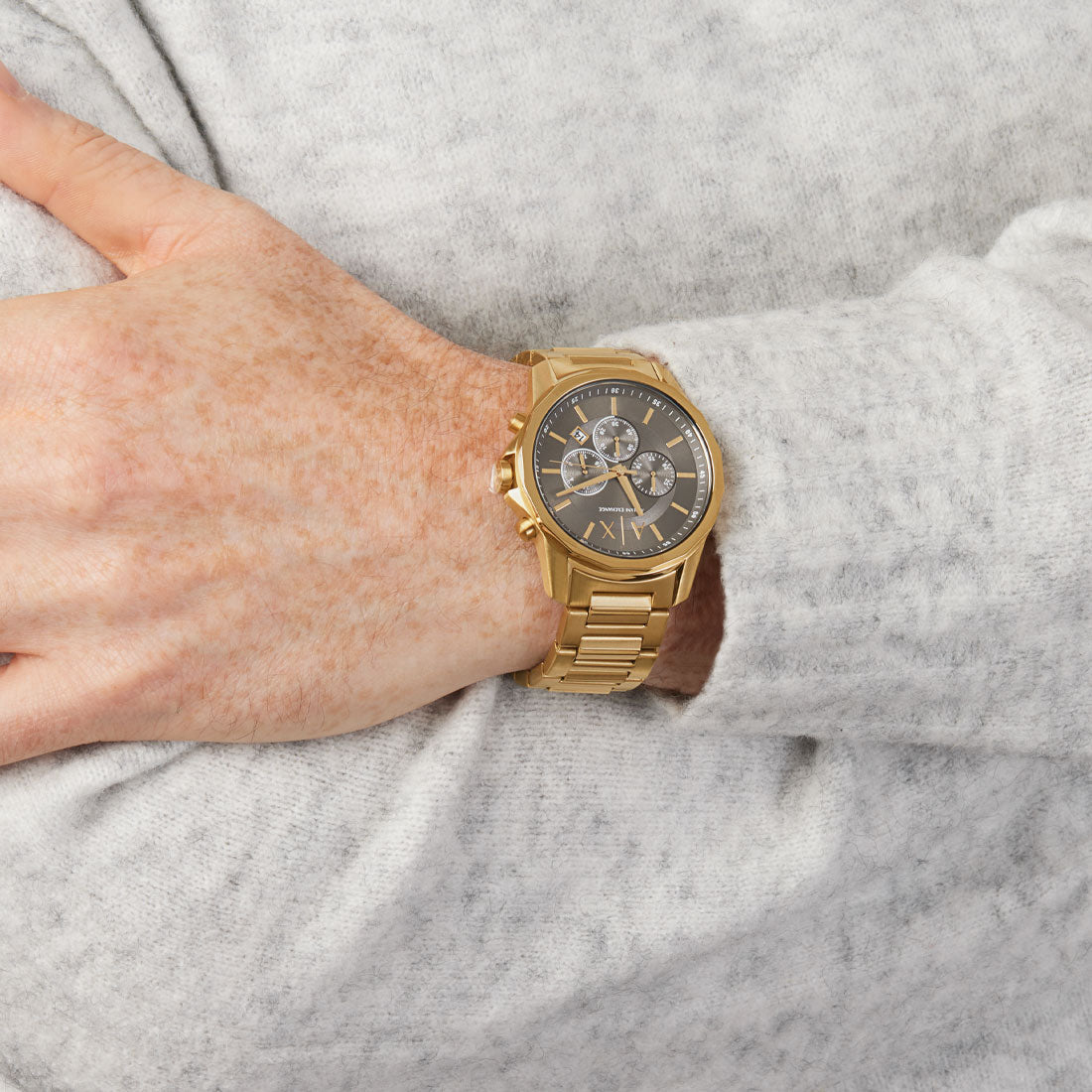 Armani Exchange AX1721 gold chronograph watch worn on wrist with grey dial