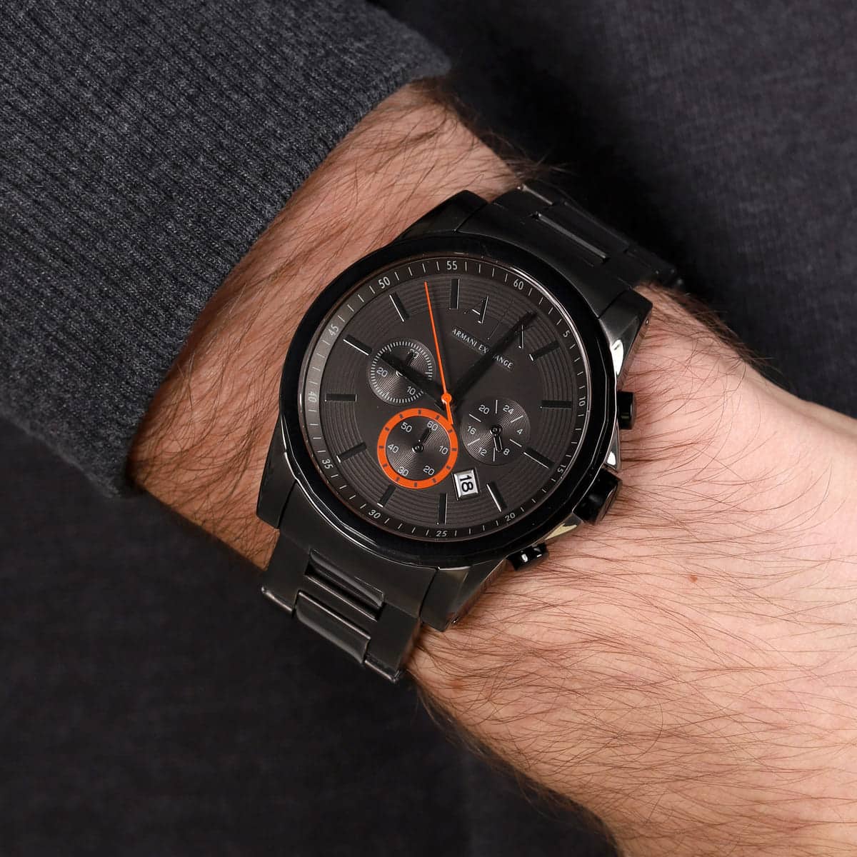 Armani Exchange AX2514 gunmetal chronograph watch worn on wrist with dark long sleeve