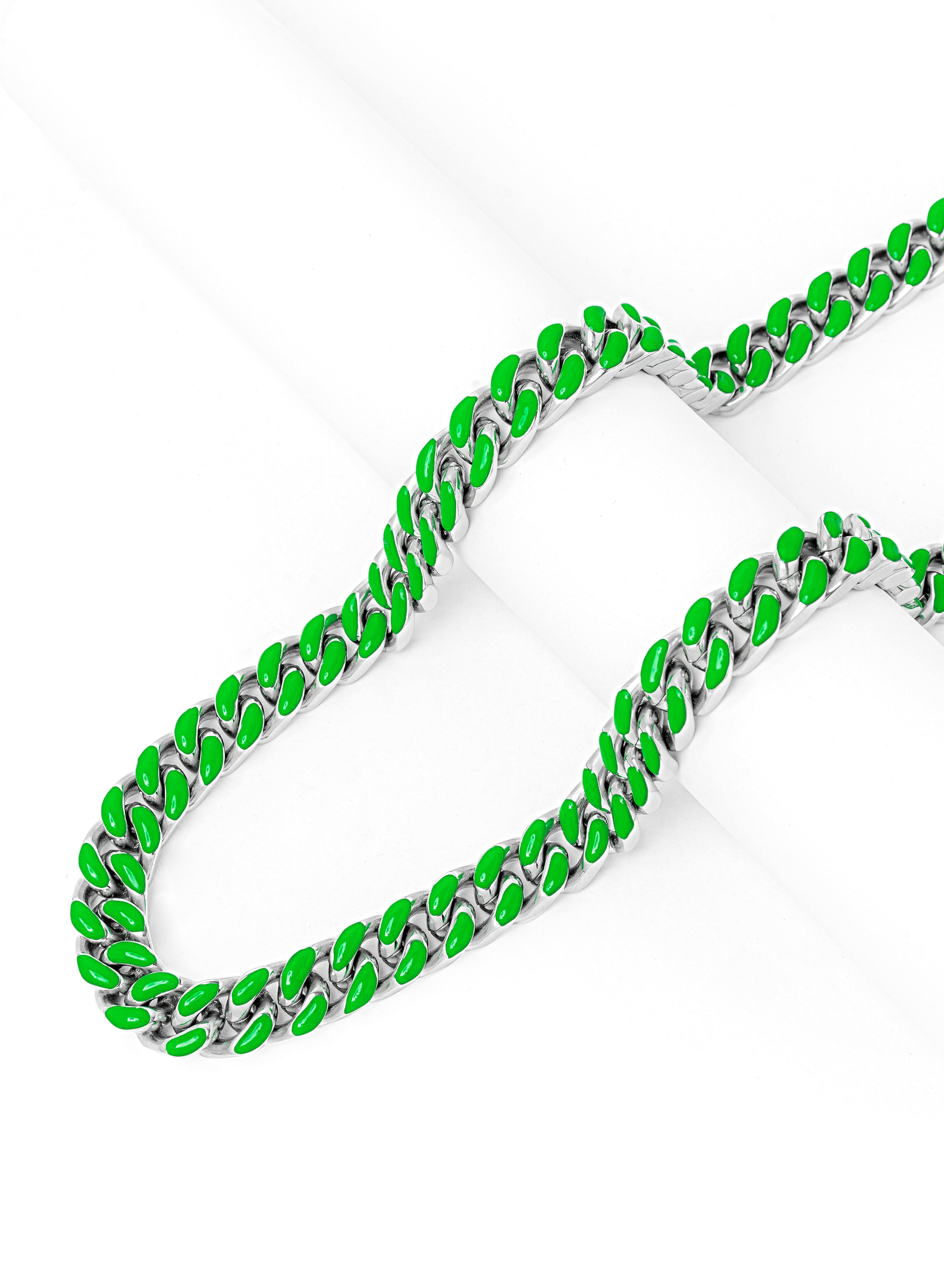 Full length view of green and silver Cuban link chain with layered display