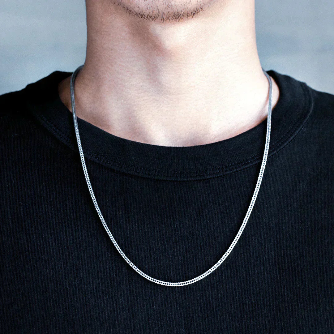 Man wearing Big Daddy 2.5mm rope silver chain around neck on black t-shirt