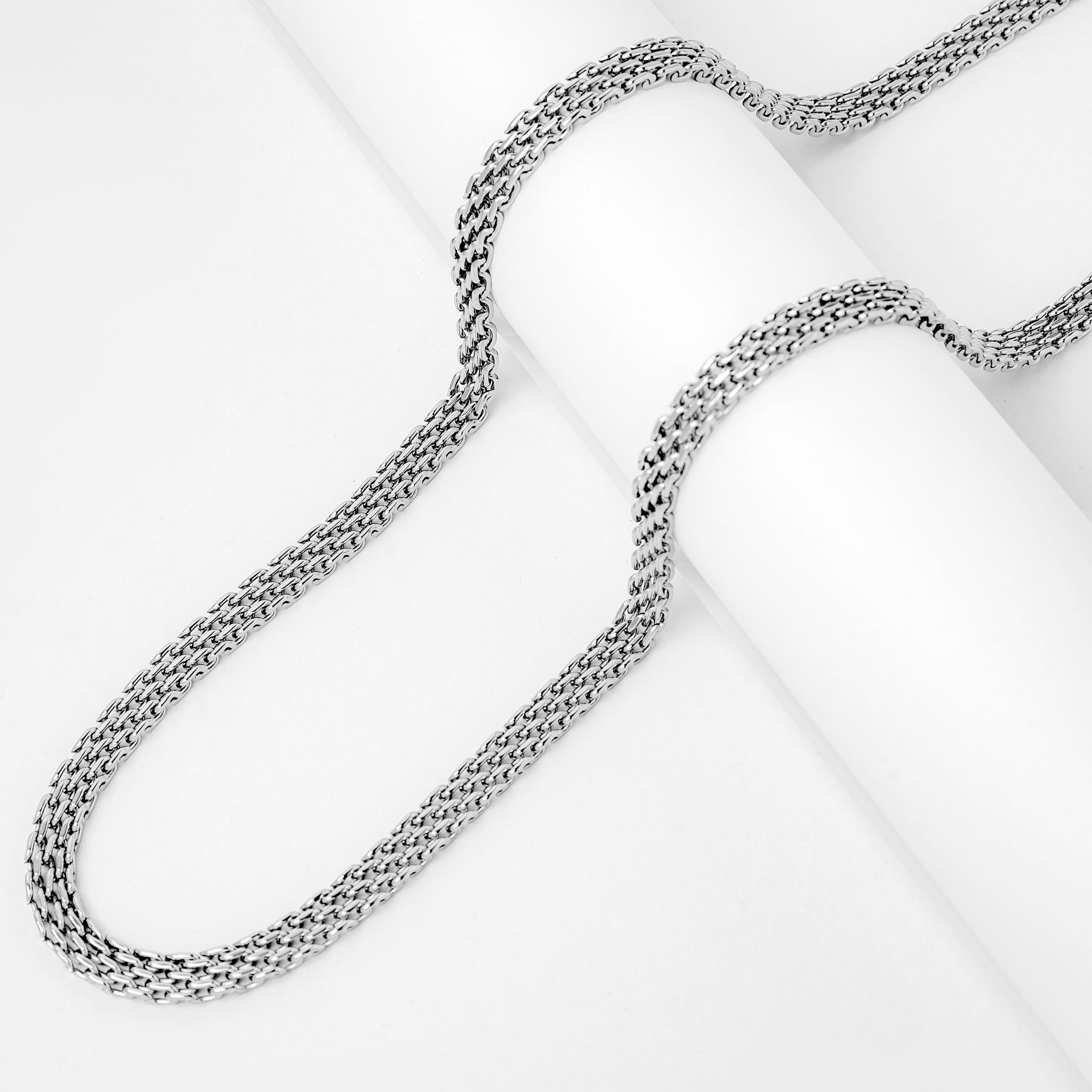 Two 6MM silver flat herringbone chains showing interlocking link pattern