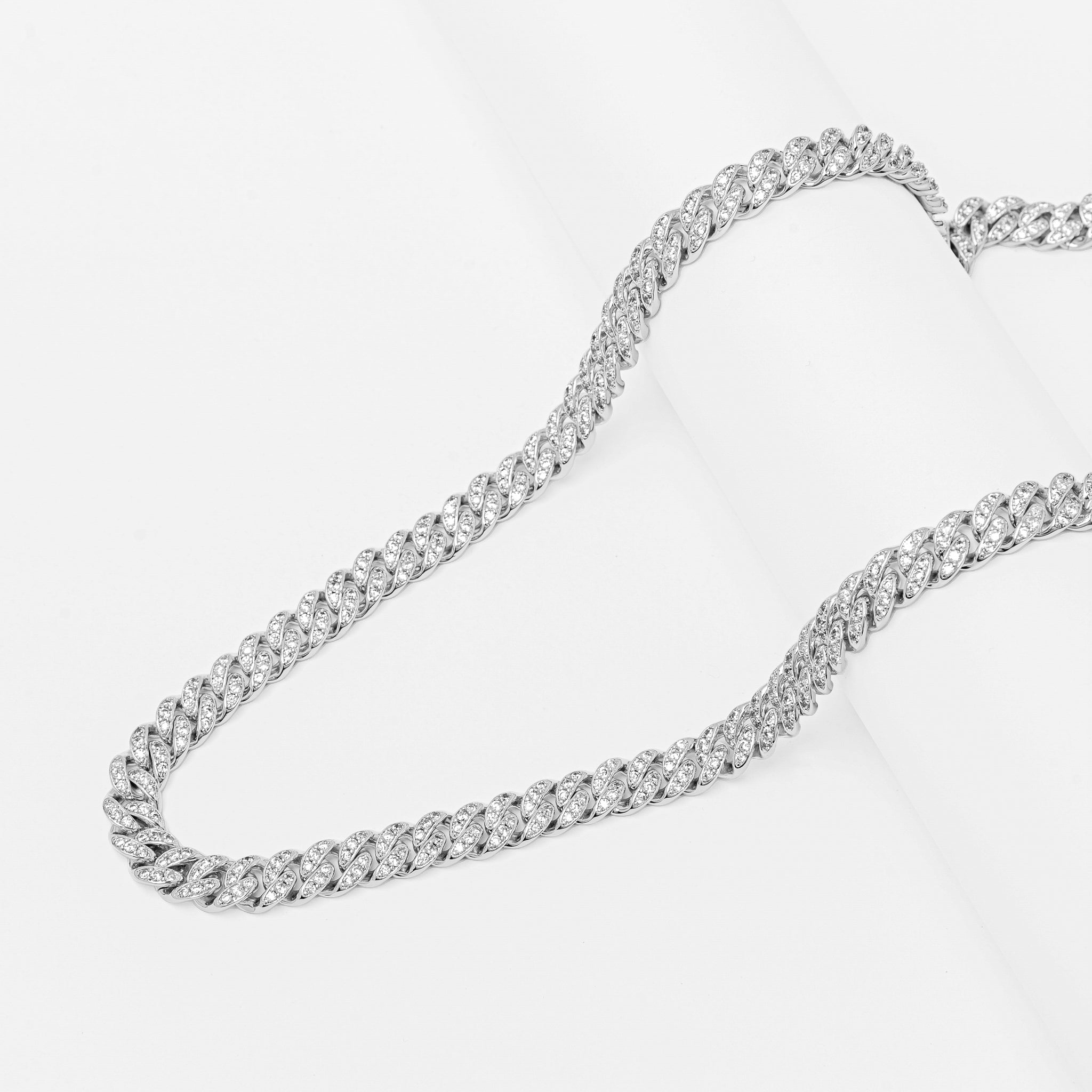 Layered view of silver Cuban link chain showing texture and sparkle