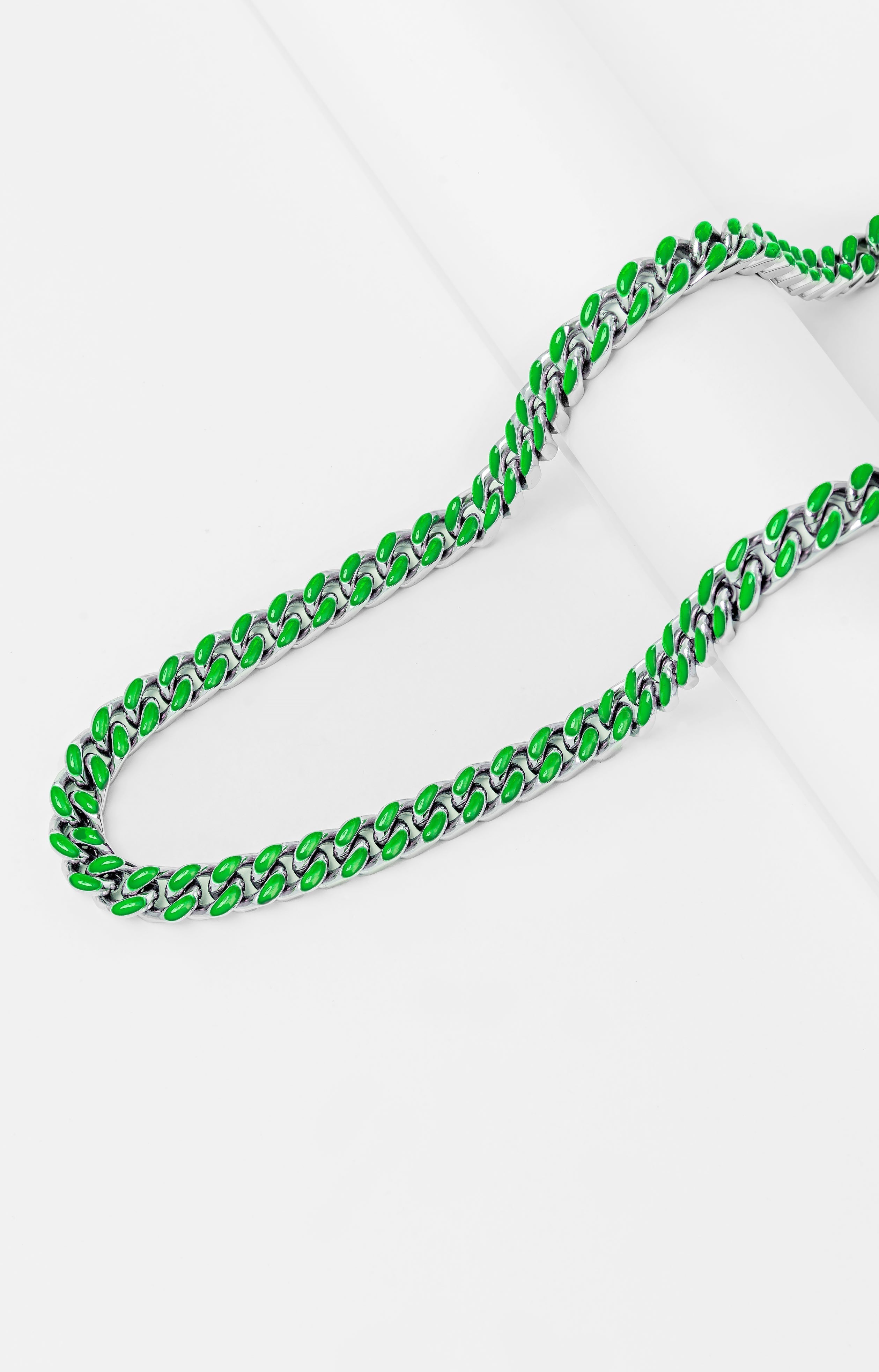 Green and silver Cuban chain links shown in curved formation, side view
