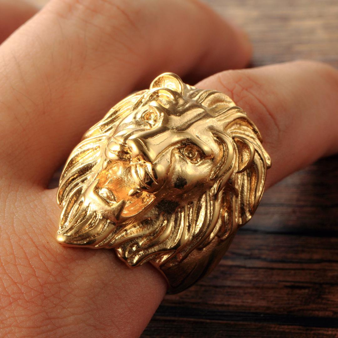 Gold lion ring worn on hand, showing polished finish and dimensional sculptural design