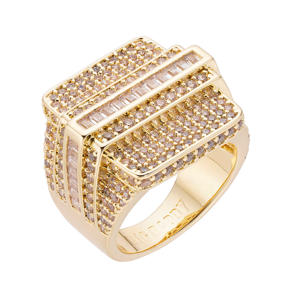 Gold-plated iced out baguette diamond ring with round and baguette-cut stones on white background
